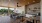 a clubroom with a couch, tables and chairs