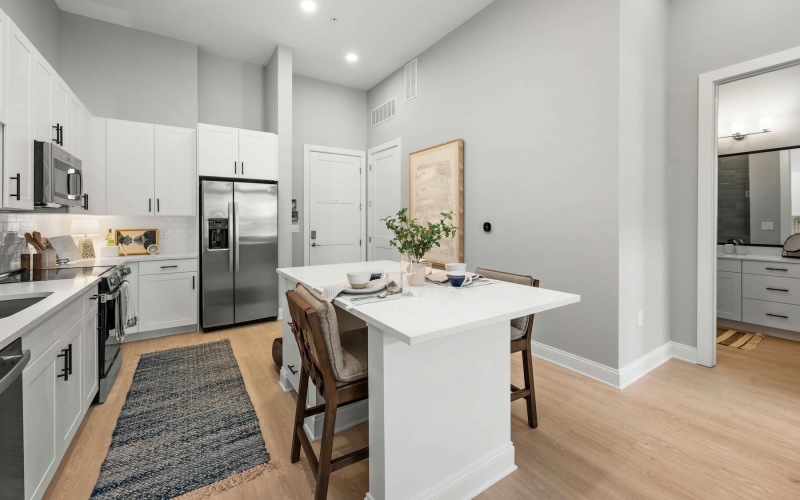 a kitchen with an island and wood floors