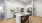 a kitchen with an island and white cabinets