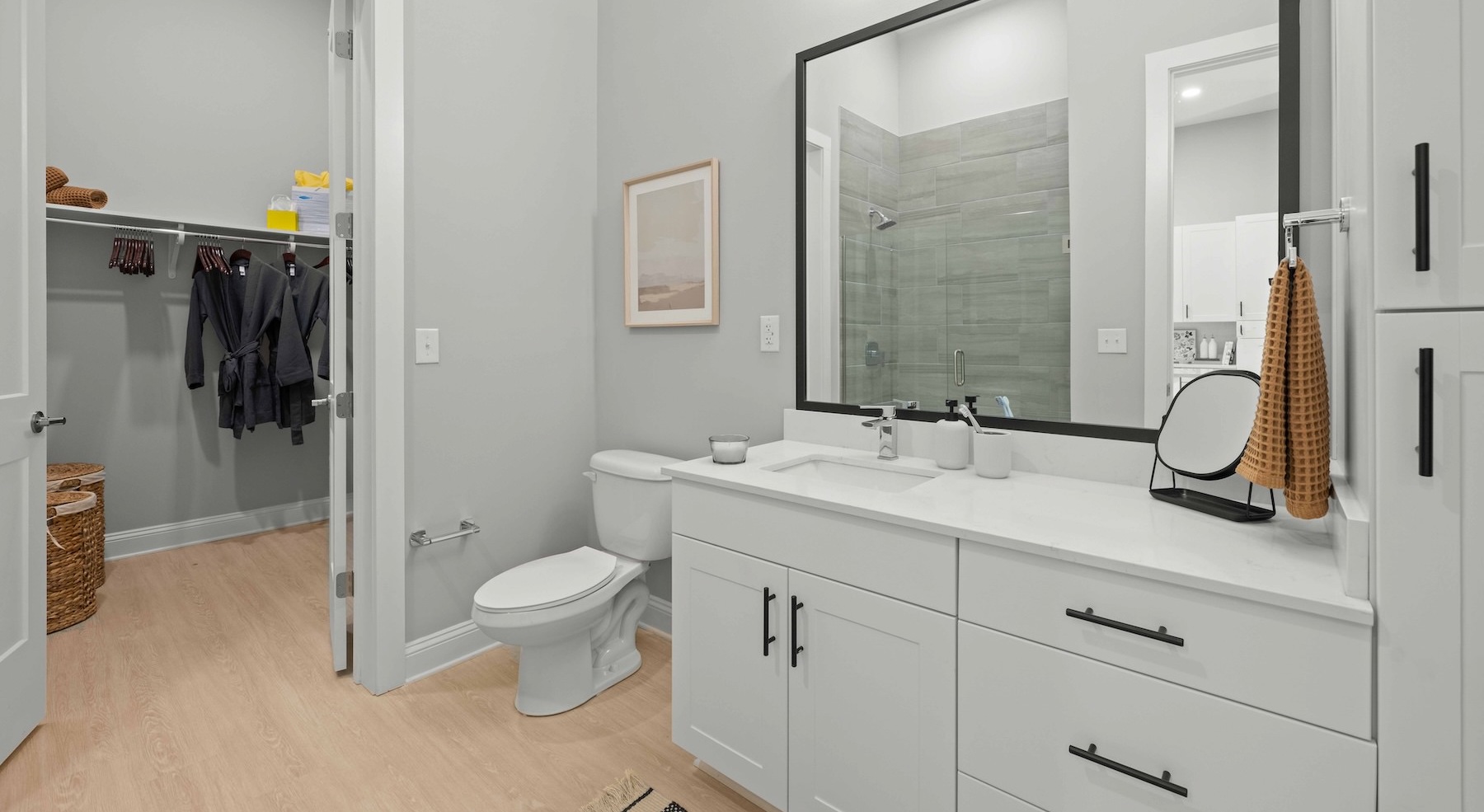 a bathroom with a toilet, sink and mirror