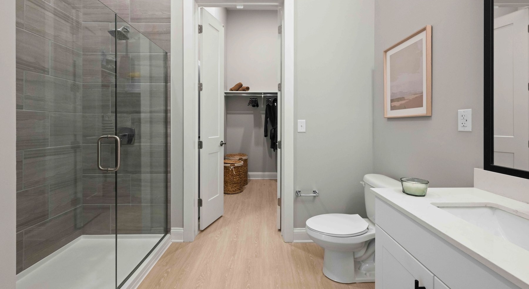 a bathroom with a shower, toilet and sink