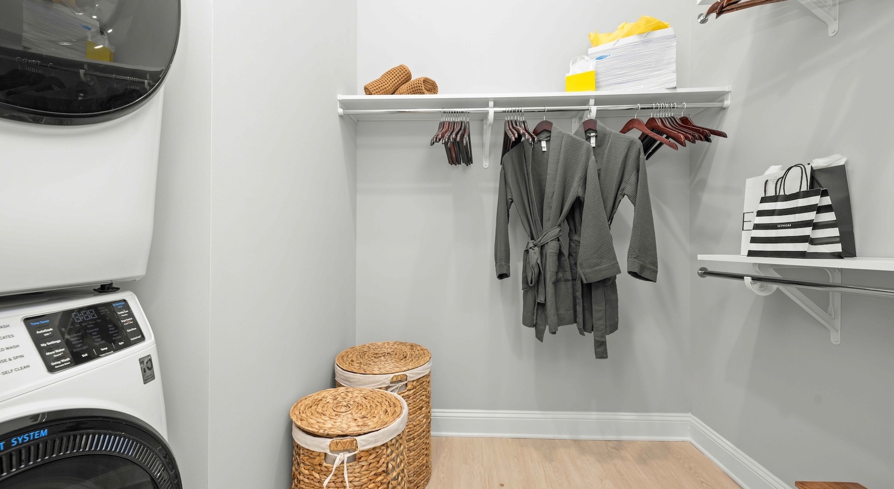 a closet with laundry and a washer and dryer
