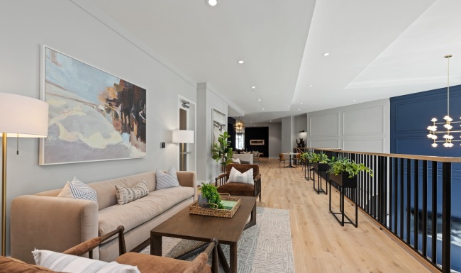 a walkway with a couch, tables and chairs