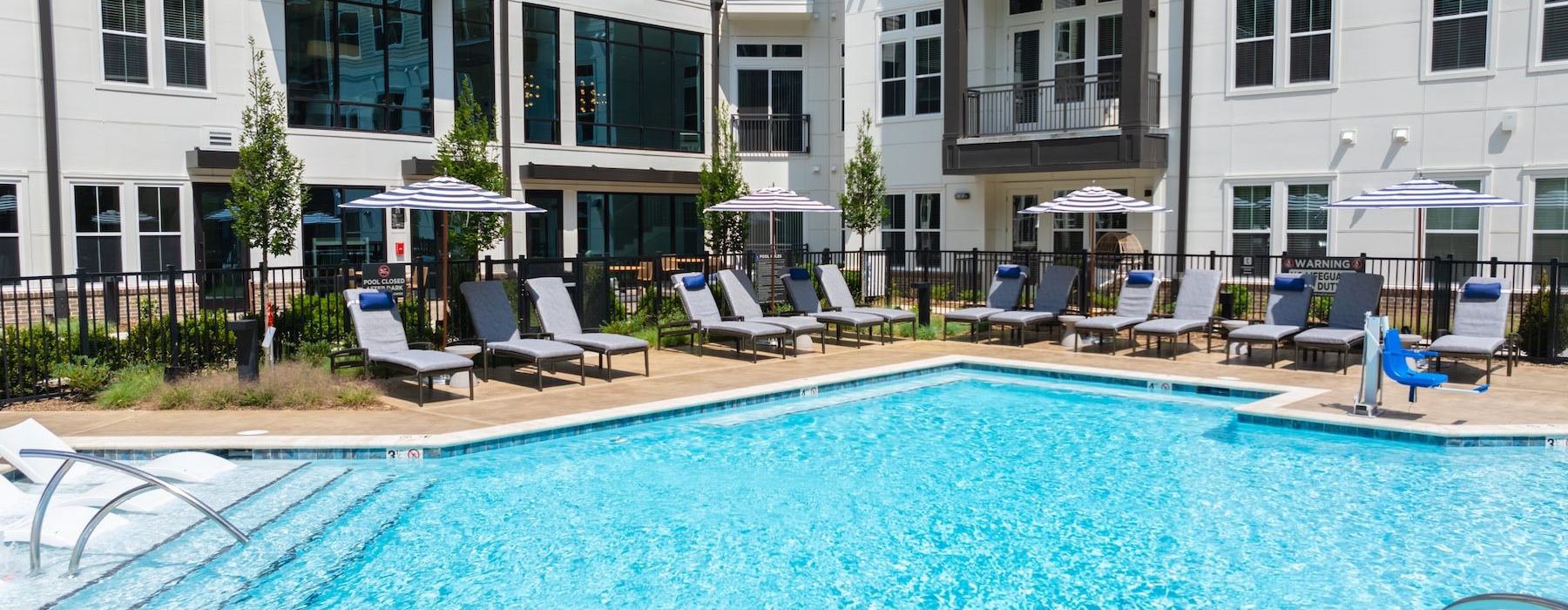 a swimming pool with chairs around it